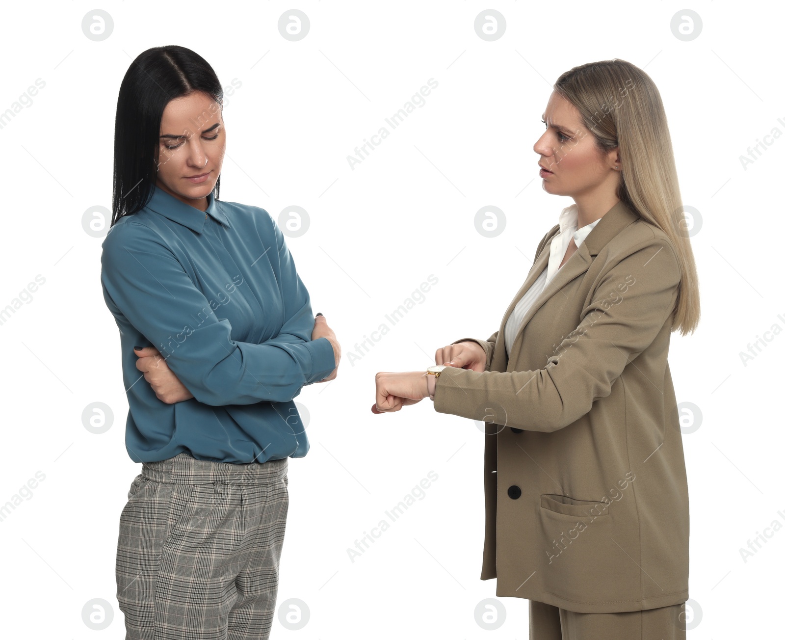 Photo of Businesswoman pointing on wrist watch while scolding employee for being late against white background