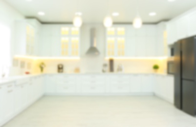 Photo of Blurred view of modern kitchen interior with stylish furniture