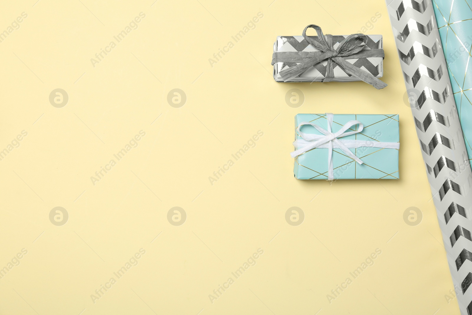 Photo of Flat lay composition with beautiful gift boxes and space for text on color background