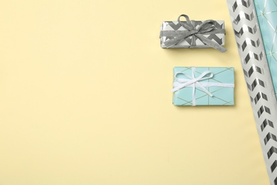 Flat lay composition with beautiful gift boxes and space for text on color background