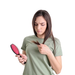 Young woman with brush on white background. Hair loss problem