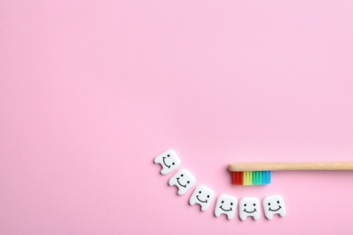 Photo of Flat lay composition with small plastic teeth and space for text on color background