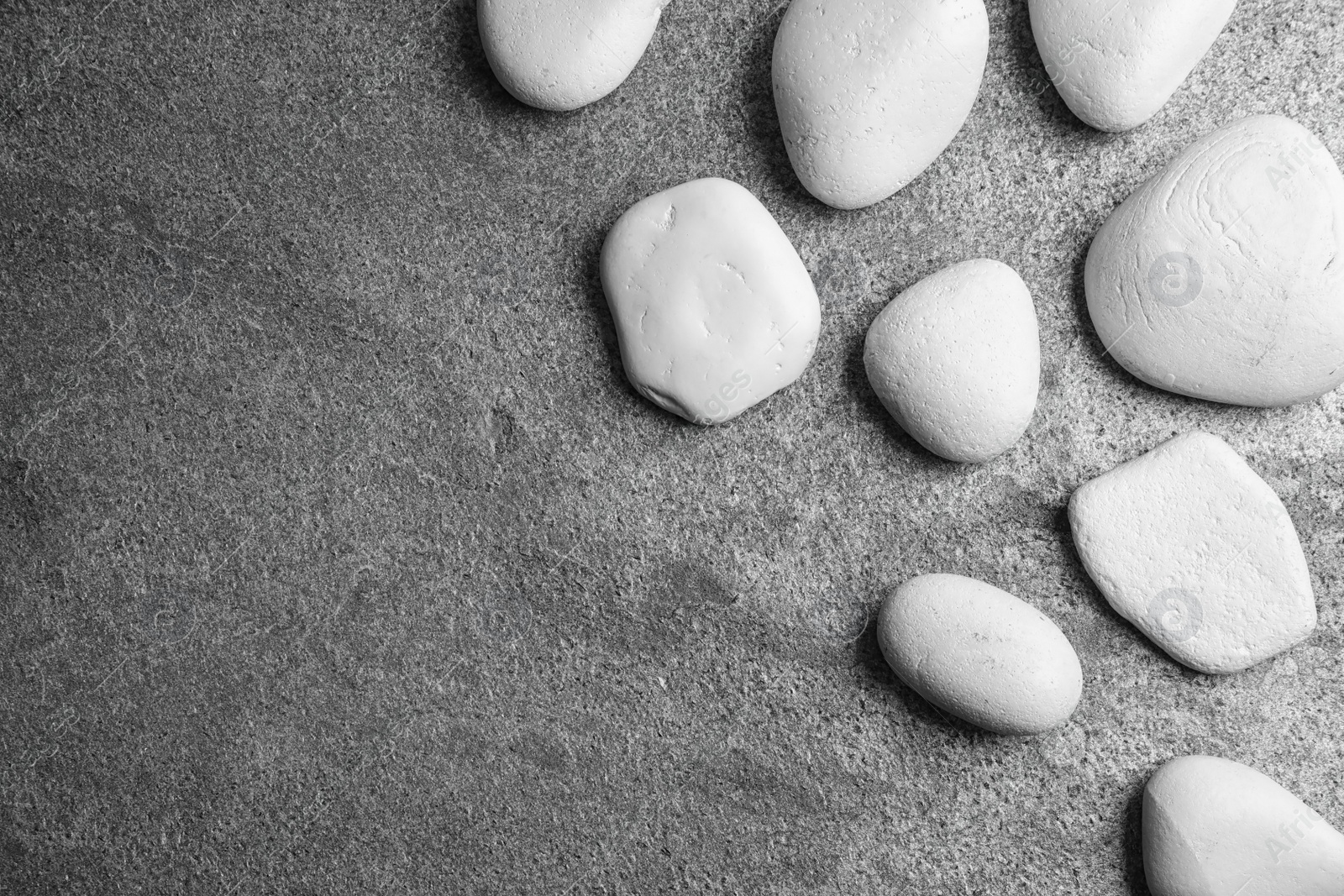 Photo of Zen stones on grey background, top view with space for text