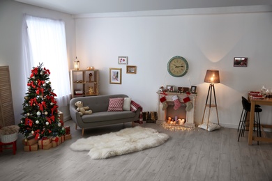 Photo of Room interior with beautiful Christmas tree and gifts