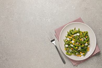 Delicious salad with green beans, corn and cheese served on light table, flat lay. Space for text