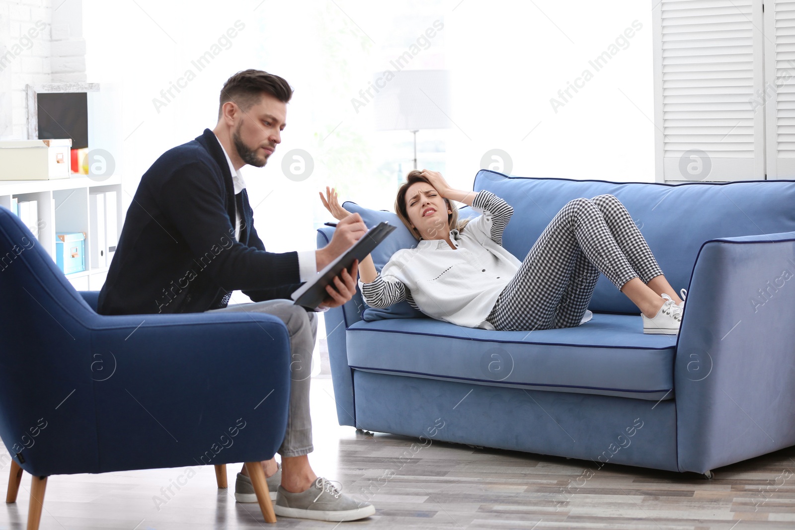 Photo of Male psychologist with client in office