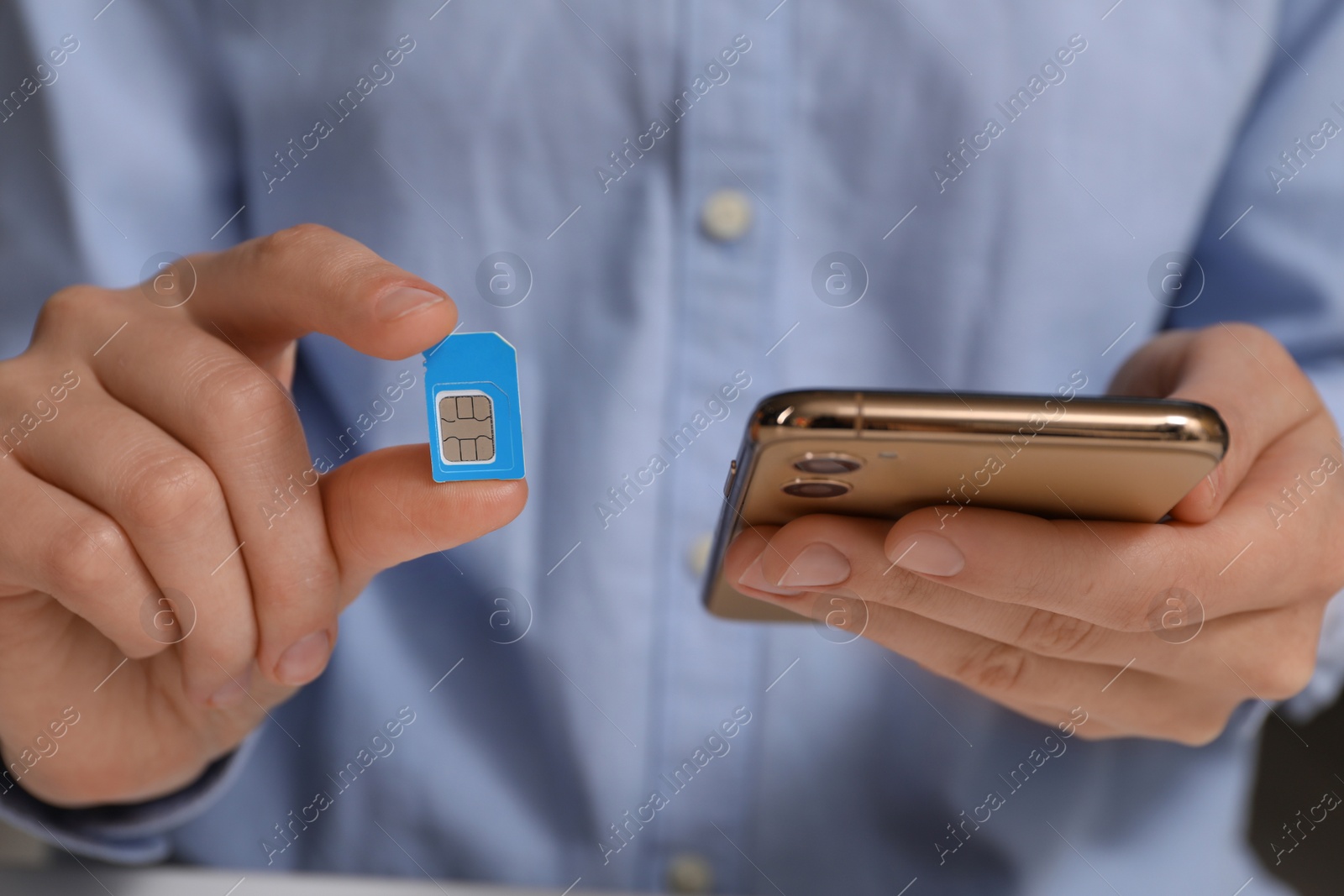 Photo of Woman with SIM card and smartphone, closeup