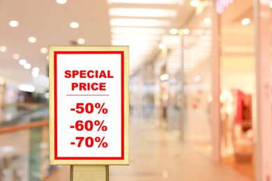 Image of Advertising board with text Special Price and list of discounts in shopping mall