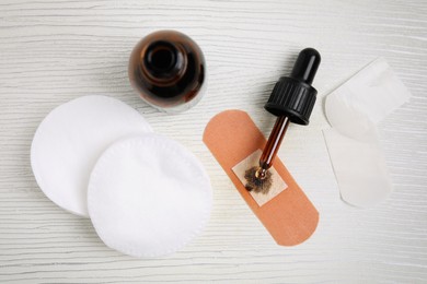 Photo of Flat lay composition with bottle of medical iodine on white wooden table