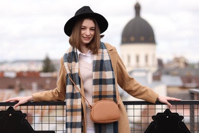 Beautiful woman in warm scarf and hat outdoors