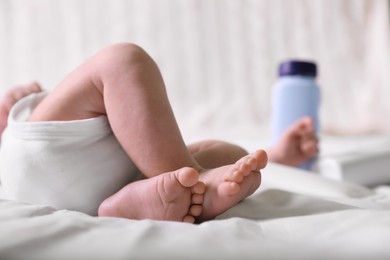 Photo of Little baby lying on bed, closeup view