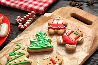 Photo of Tasty homemade Christmas cookies on wooden board