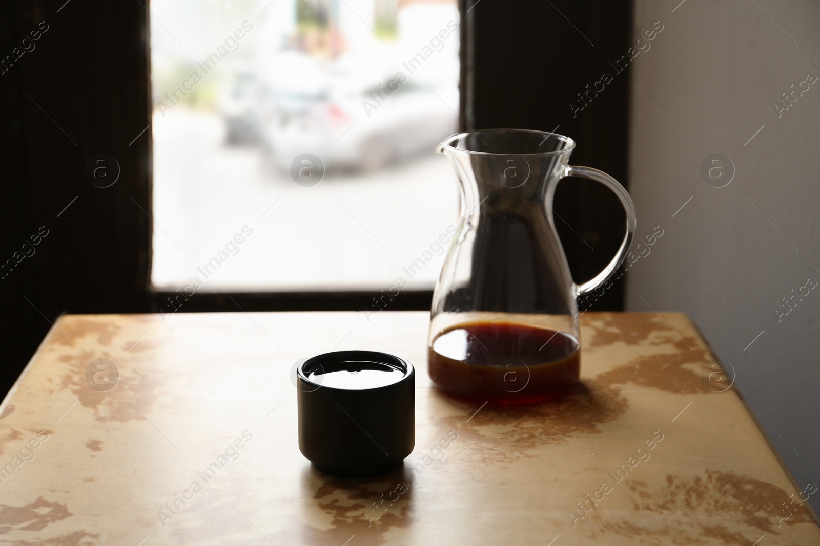 Photo of Aromatic coffee on light brown table in cafe