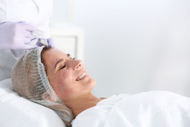 Photo of Woman undergoing face biorevitalization procedure in salon. Cosmetic treatment