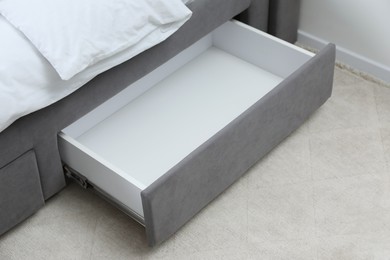 Storage drawer for bedding under modern bed in room