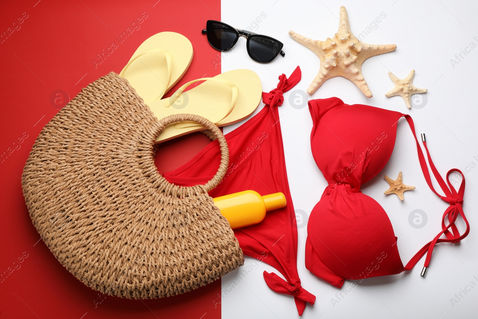 Photo of Stylish bag with beach accessories on color background, flat lay