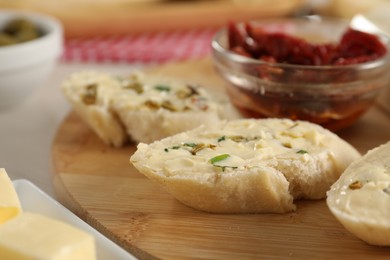 Photo of Tasty butter with spices and bread on table, closeup