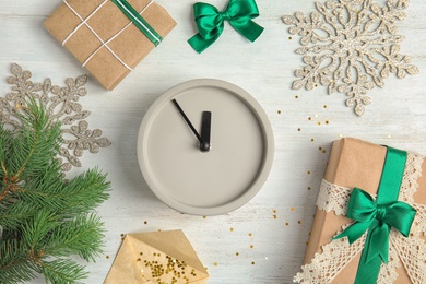 Flat lay composition with clock, gifts and decorations on wooden background. Christmas countdown