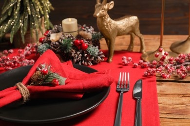 Photo of Festive place setting with beautiful dishware, cutlery and decor for Christmas dinner on wooden table