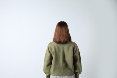 Photo of Girl wearing cardigan on white background, back view