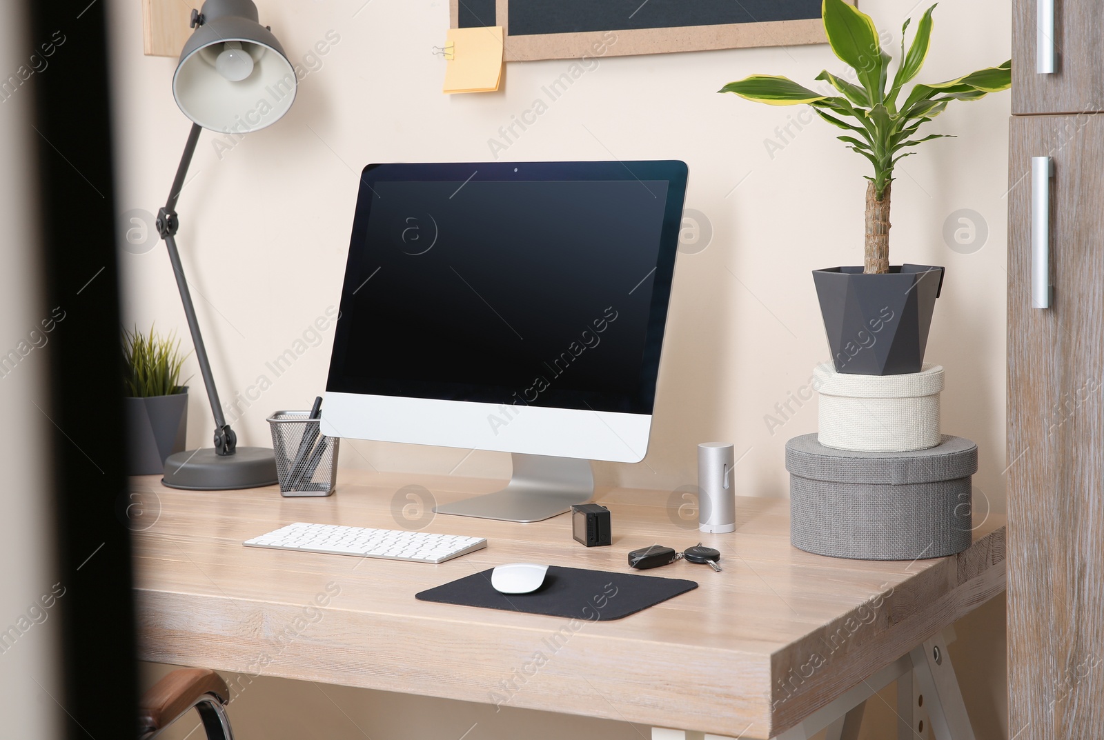 Photo of Interior of comfortable work place with computer on table at home