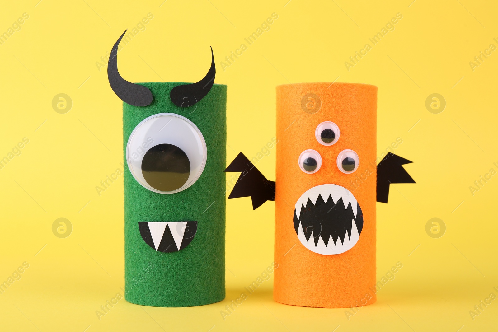 Photo of Spooky monsters on yellow background. Handmade Halloween decoration