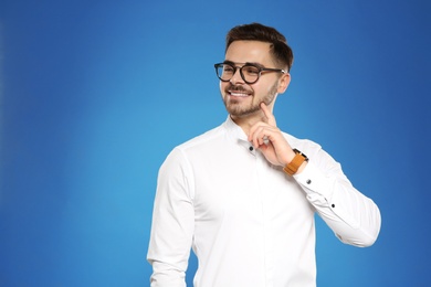 Photo of Portrait of handsome young man with glasses on color background