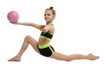 Photo of Cute little girl with ball doing gymnastic exercise on white background