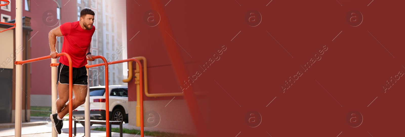 Image of Handsome man training on parallel bars at outdoor gym, space for text. Banner design