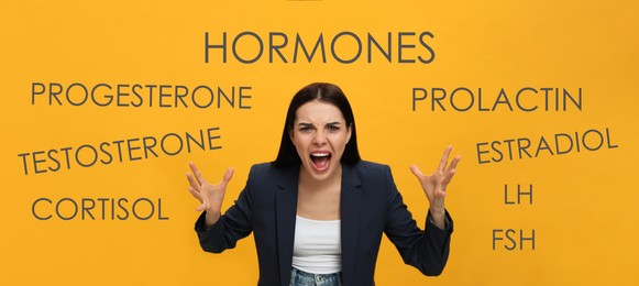 Image of Hormones imbalance. Annoyed young woman and different words on yellow background, banner design