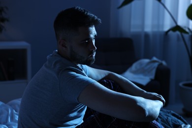 Photo of Frustrated man suffering from insomnia at night