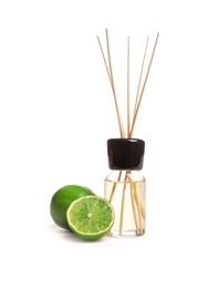 Aromatic reed air freshener and lime on white background