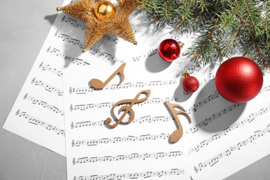 Composition with wooden music notes and decorations on grey background, top view