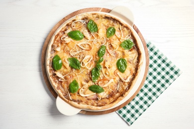 Photo of Delicious homemade pizza served on wooden table, top view