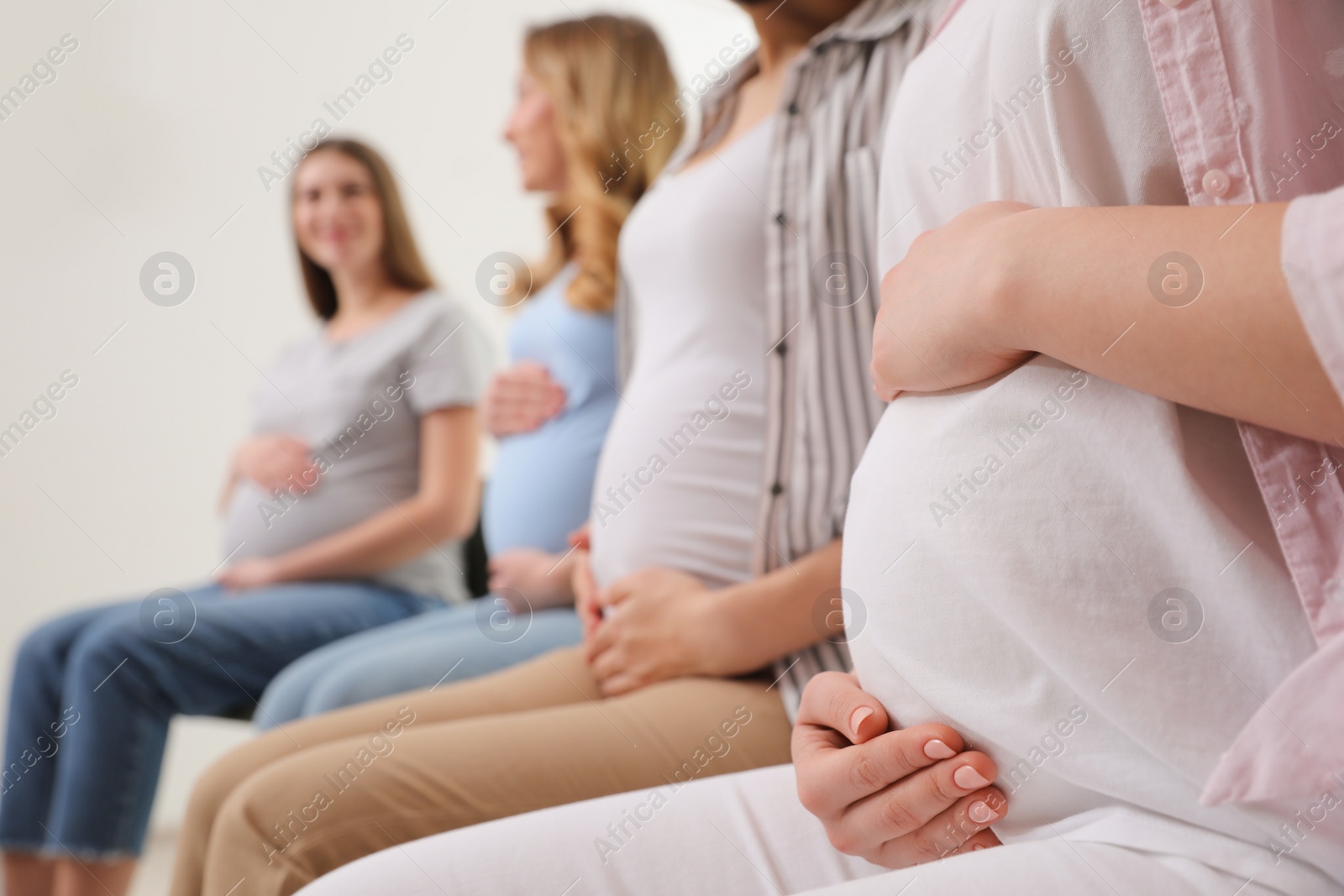 Photo of Group of pregnant women at courses for expectant mothers indoors, closeup