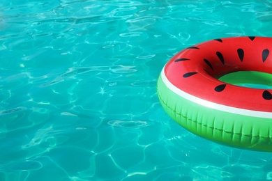 Inflatable ring floating in swimming pool on sunny day. Space for text