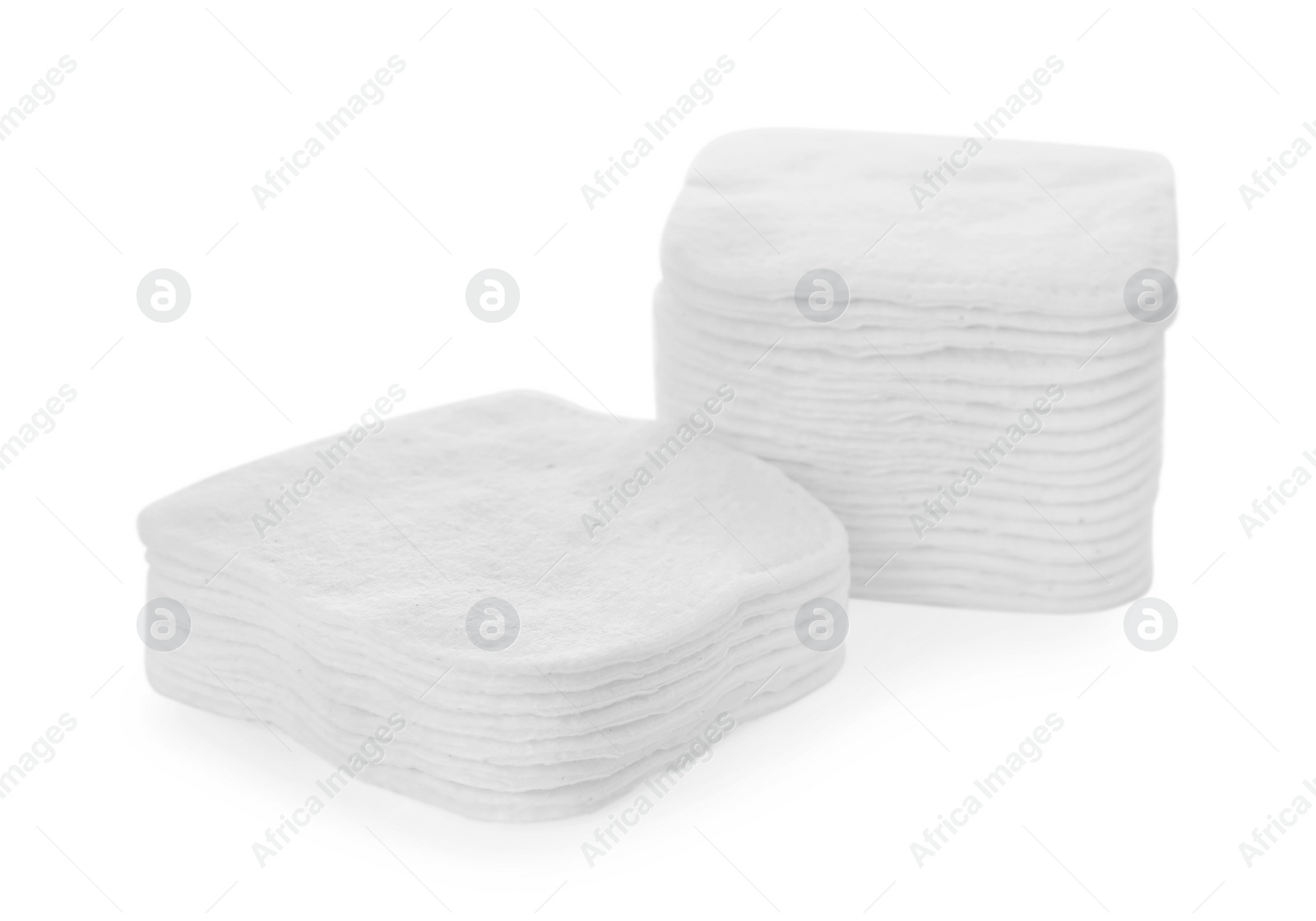 Photo of Stacks of cotton pads on white background