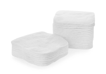 Stacks of cotton pads on white background