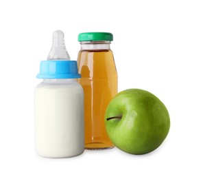 Photo of Bottles with juice, milk and ripe apple on light grey background. Baby nutrition