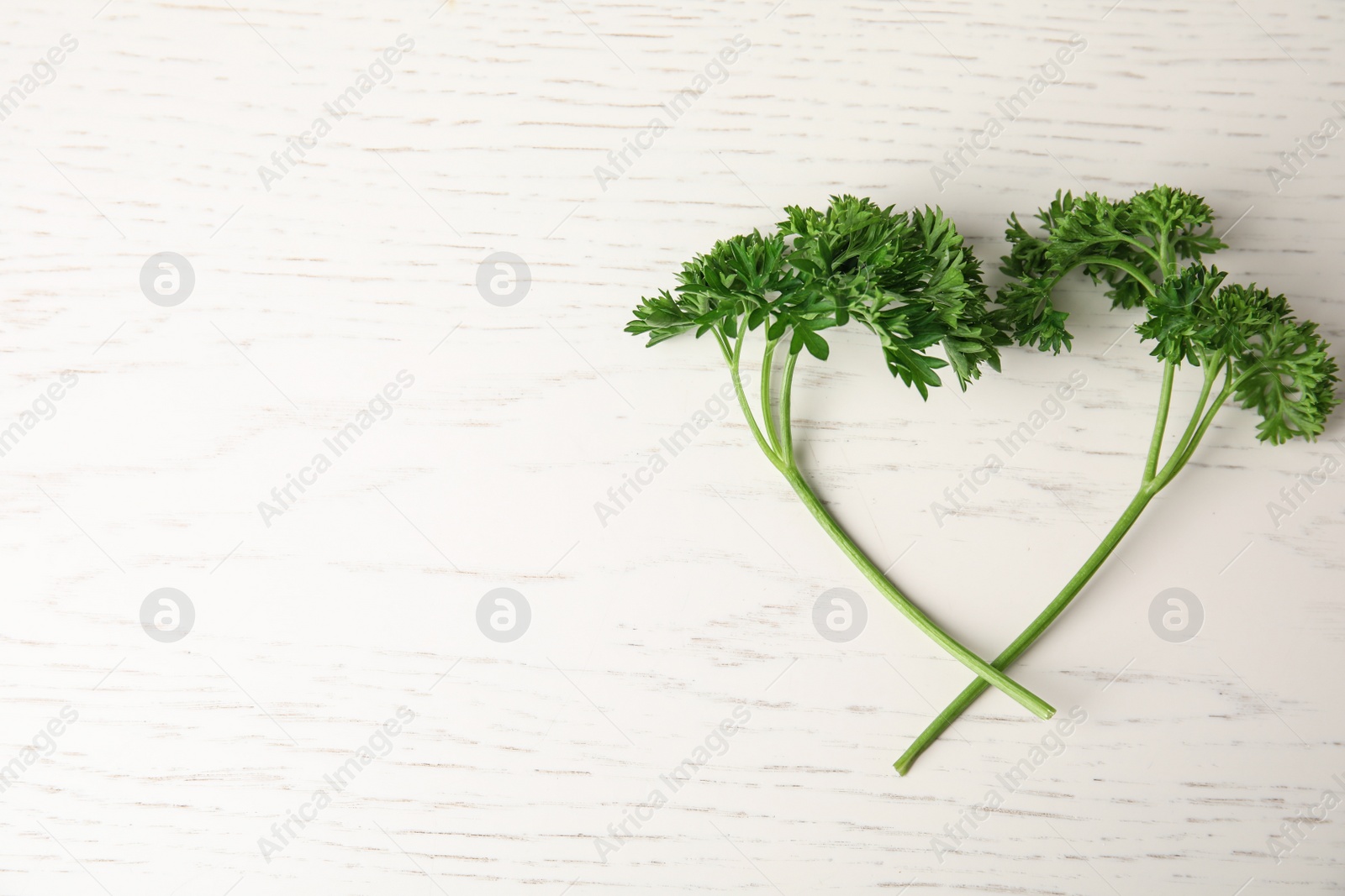 Photo of Fresh green parsley on white wooden table, flat lay. Space for text