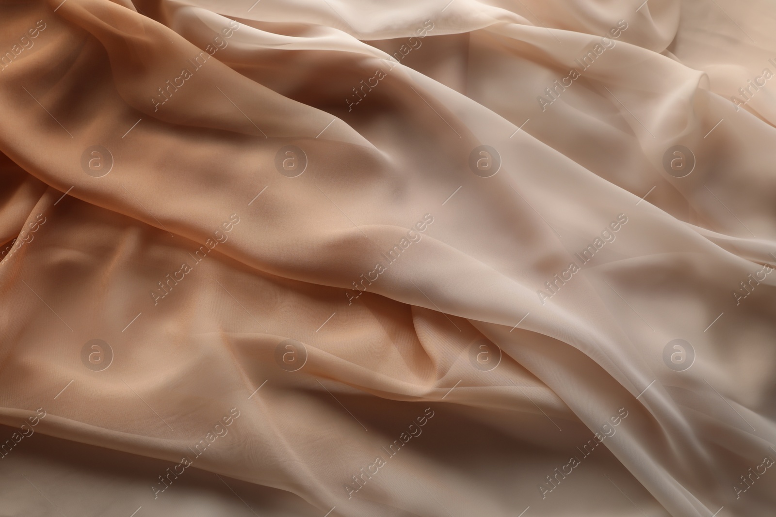 Photo of Beautiful beige tulle fabric as background, top view