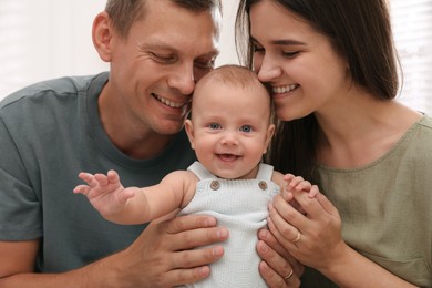 Photo of Happy family with their cute baby indoors