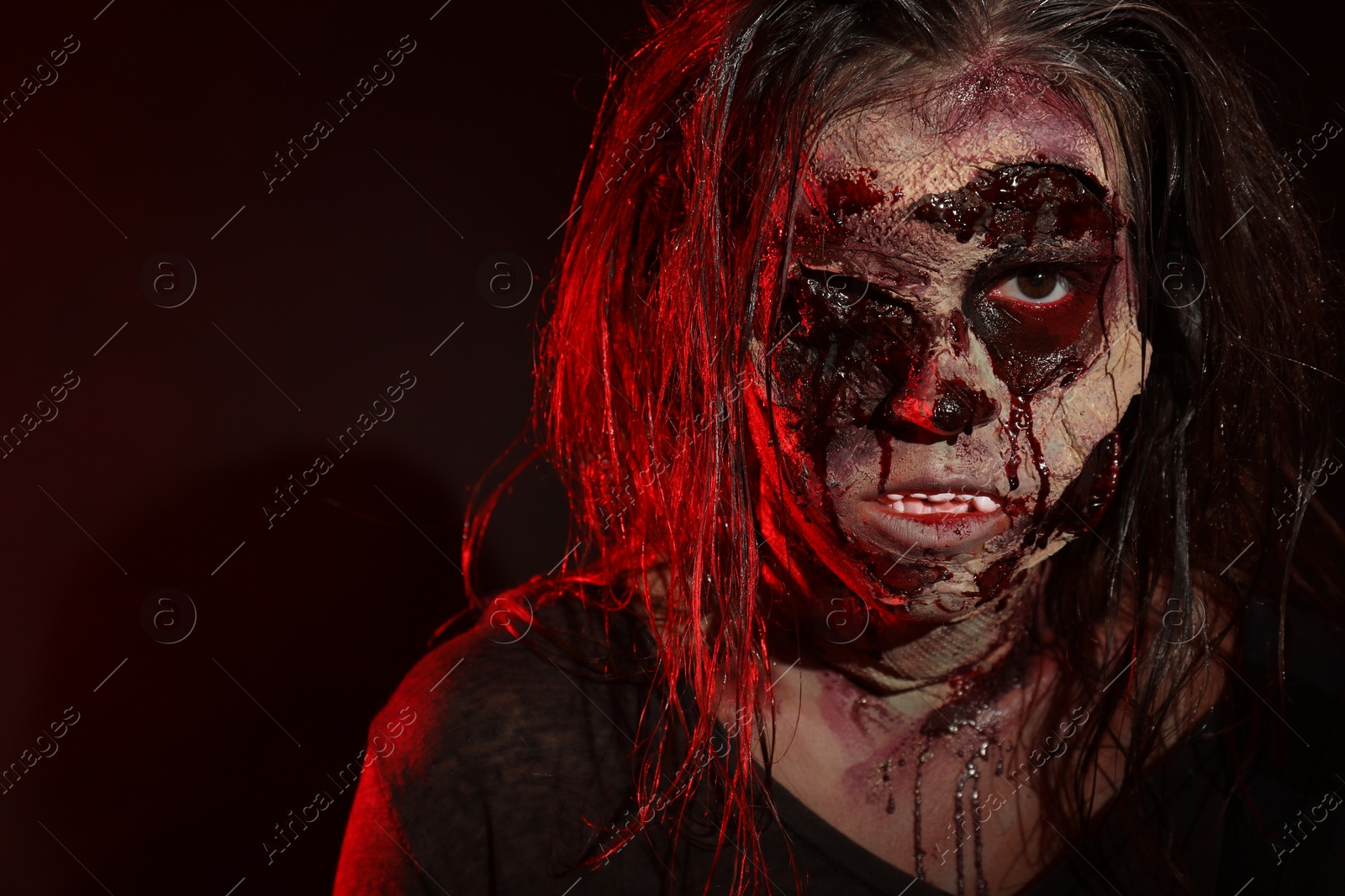 Photo of Scary zombie on dark background, closeup. Halloween monster