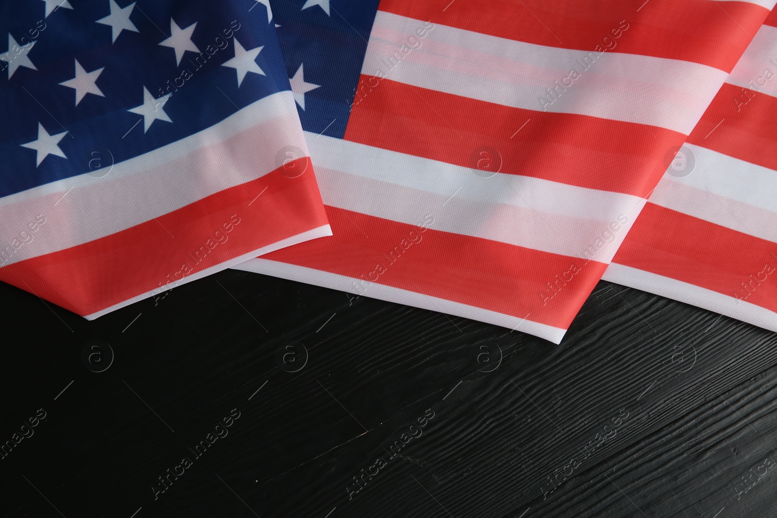 Photo of Flag of USA on black wooden table, top view