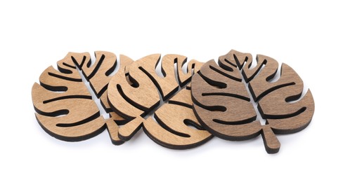 Leaf shaped wooden cup coasters on white background