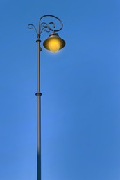 Image of Beautiful old fashioned street lamp lighting outdoors