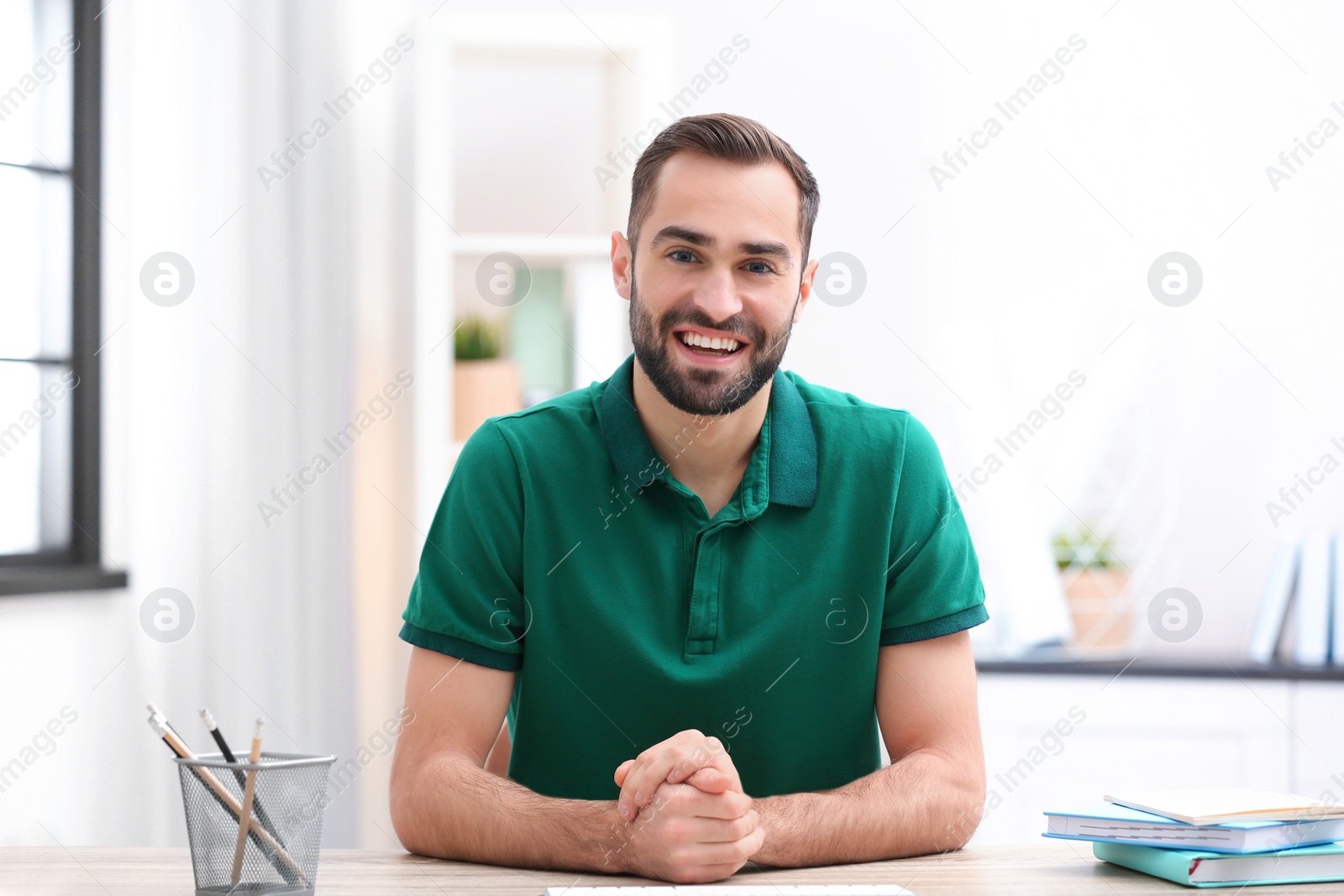 Photo of Handsome man using video chat for conversation indoors