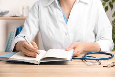 Doctor working at desk in office, closeup. Medical service