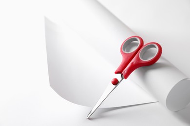 Photo of Red scissors and paper on white background. Space for text