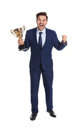 Photo of Full length portrait of happy young businessman with gold trophy cup on white background